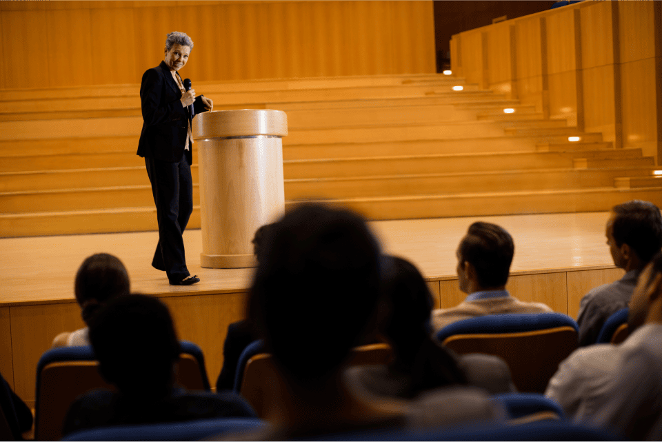 female-business-executive-giving-speech 1